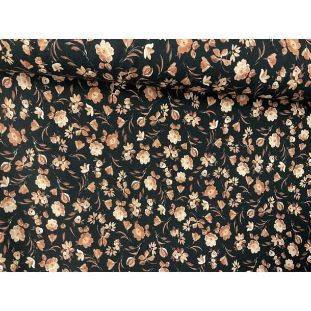 Bomulds jersey sort bund med brndt orange gyldne sm blomster. 129 kr pr m