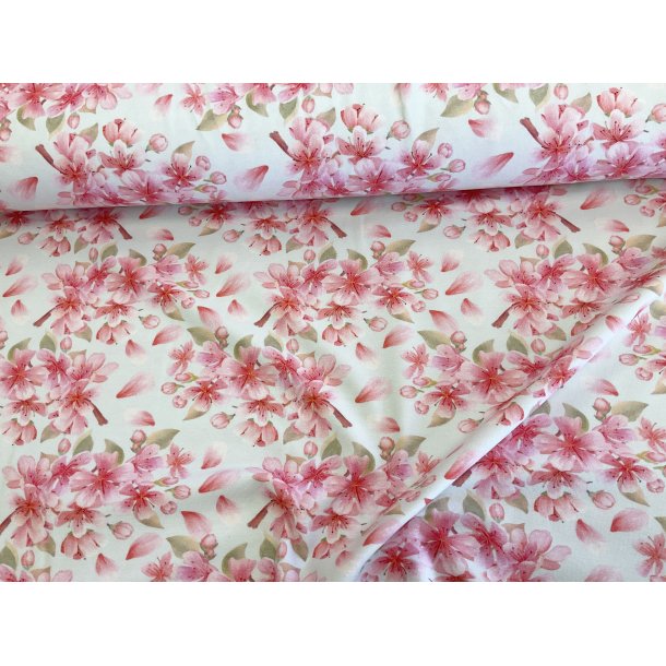 Bomulds jersey lys mint bund med lyserde blomster. 145 kr pr m