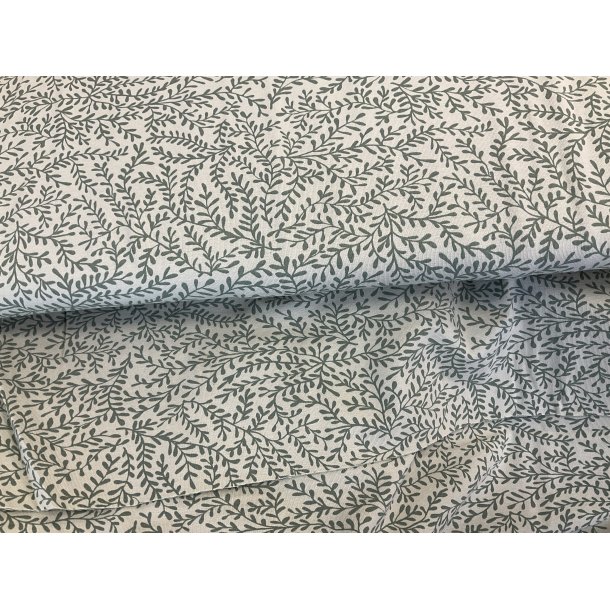 Bomulds jersey lys stvet grn bund med army grnne grene. 119 kr pr m